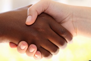 Two hands respectfully shaking hands.