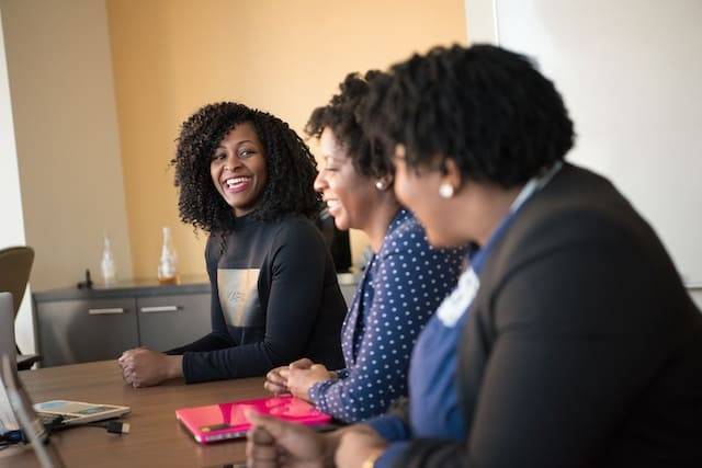 Three, happy business women having a meeting.