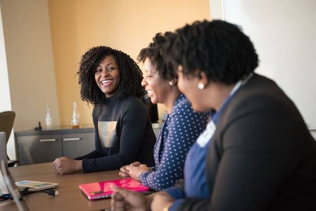 Three, happy business women having a meeting.